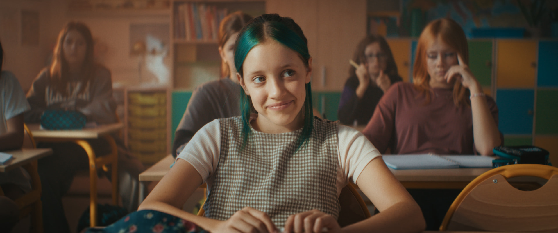 Still from Pixie: New Beginning — a girl at her school desk